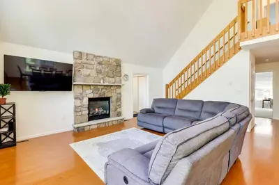 a living room with a couch and a fireplace at Huge Deck Stunning Pocono Lake Vacation Rental! in Pocono Lake