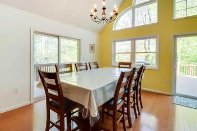 a dining room with a table and chairs at Huge Deck Stunning Pocono Lake Vacation Rental! in Pocono Lake