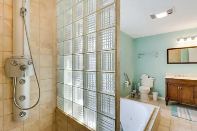 a bathroom with a shower and a tub and a toilet at Huge Deck Stunning Pocono Lake Vacation Rental! in Pocono Lake