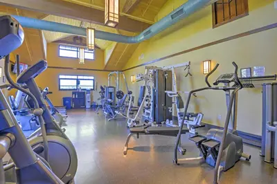 a gym with several tread machines in a room at Huge Deck Stunning Pocono Lake Vacation Rental! in Pocono Lake