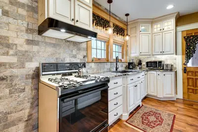a kitchen with white cabinets and a stove top oven at Pennsylvania Abode Near Little League World Series in Williamsport