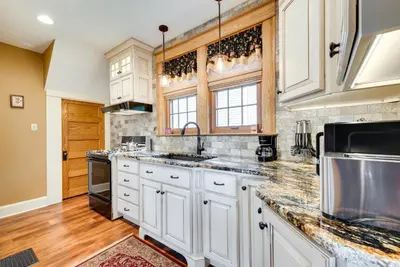 a kitchen with white cabinets and marble counter tops at Pennsylvania Abode Near Little League World Series in Williamsport