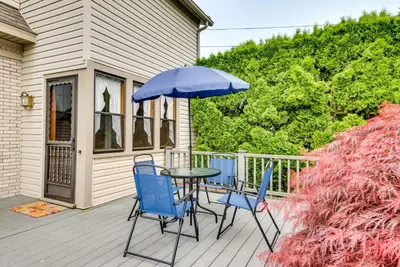 a table and chairs with an umbrella on a porch at Pennsylvania Abode Near Little League World Series in Williamsport