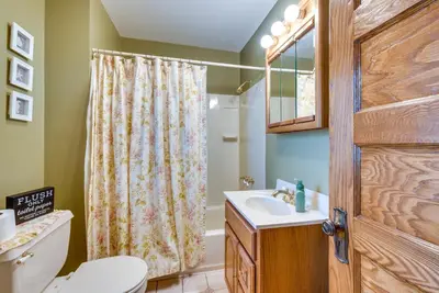a bathroom with a toilet sink and a shower curtain at Pennsylvania Abode Near Little League World Series in Williamsport