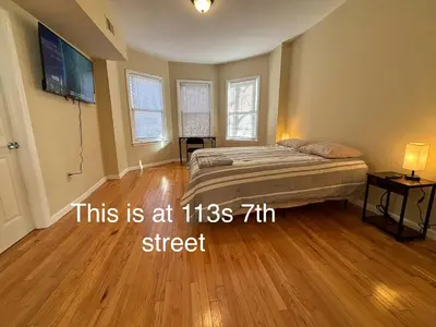 a bedroom with a bed and a hard wood floor at Willoughby in Newark
