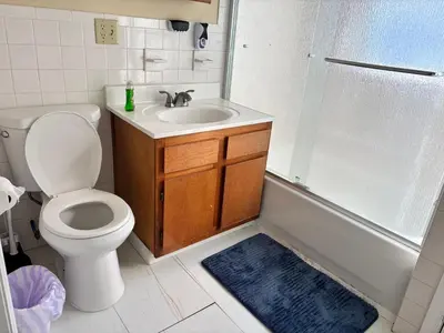 a bathroom with a toilet and a sink and a shower at Willoughby in Newark