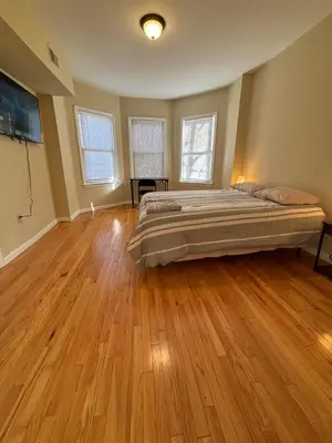a bedroom with a bed and a wooden floor at Willoughby in Newark