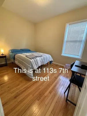 a bedroom with a bed and a wooden floor at Willoughby in Newark