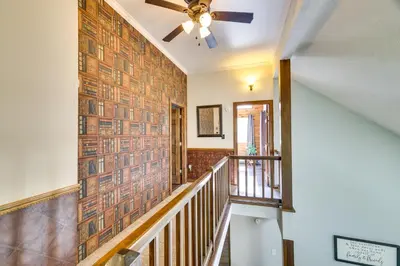 a hallway with a staircase with a ceiling fan at Exciting Tobyhanna Home Near Kalahari Water Park! in Tobyhanna