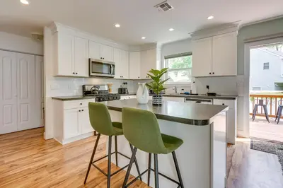 a kitchen with white cabinets and green bar stools at Gorgeous Keansburg Home with Pool Walk to Beach! in Keansburg