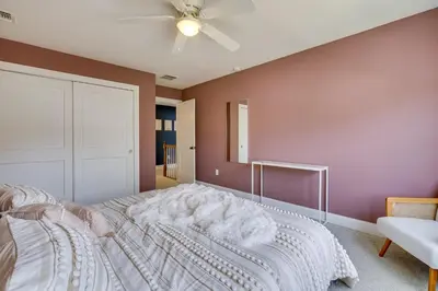 a bedroom with a bed and a ceiling fan at Gorgeous Keansburg Home with Pool Walk to Beach! in Keansburg