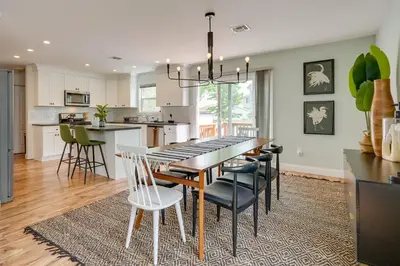 a kitchen and dining room with a table and chairs at Gorgeous Keansburg Home with Pool Walk to Beach! in Keansburg