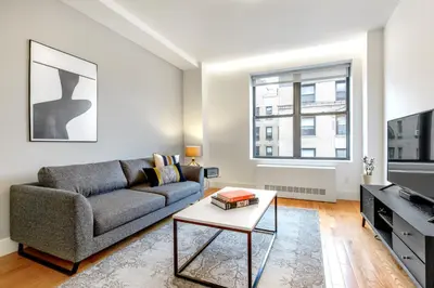a living room with a couch and a tv at UWS 1BR w Gym WD Doorman nr Central Park NYC-377 in New York