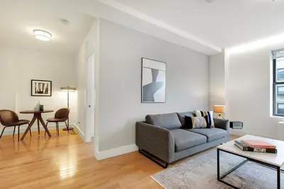 a living room with a couch and a table at UWS 1BR w Gym WD Doorman nr Central Park NYC-377 in New York