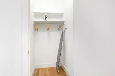 a hallway with a shelf with shoes on it at UWS 1BR w Gym WD Doorman nr Central Park NYC-377 in New York