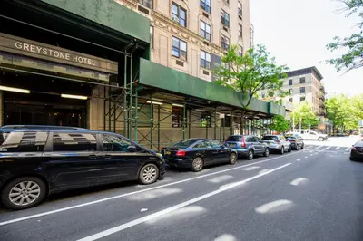 a row of cars parked on the side of a street at UWS 1BR w Gym WD Doorman nr Central Park NYC-377 in New York