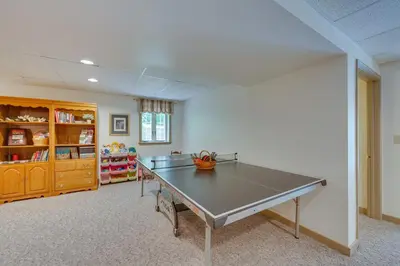 an empty room with a table in a classroom at The Haven at Welsh Mountain Suites - Apt with Patio! in New Holland