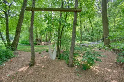 a hammock in the middle of a forest at The Haven at Welsh Mountain Suites - Apt with Patio! in New Holland
