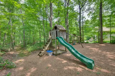 a playground in the woods with a slide at The Haven at Welsh Mountain Suites - Apt with Patio! in New Holland