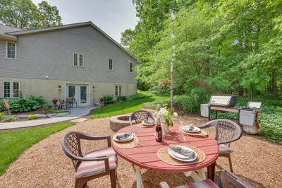 a red table and chairs in a yard at The Haven at Welsh Mountain Suites - Apt with Patio! in New Holland
