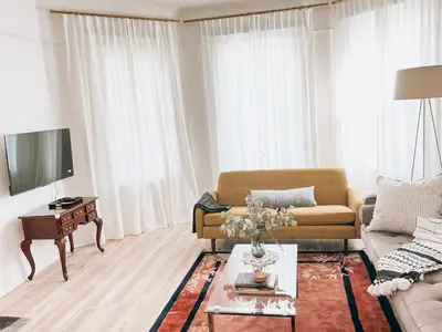 a living room with a couch and a table at Designer Home 2 Bedroom - 20min to NYC WTC - Private Backyard in Harrison