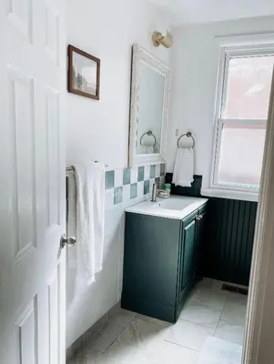 a bathroom with a blue sink and a mirror at Designer Home 2 Bedroom - 20min to NYC WTC - Private Backyard in Harrison