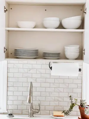 a kitchen sink with plates and bowls on shelves at Designer Home 2 Bedroom - 20min to NYC WTC - Private Backyard in Harrison