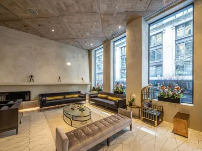 a large living room with couches and a table at The Marmara Park Avenue in New York
