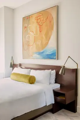 a bedroom with a bed with a large painting on the wall at The Marmara Park Avenue in New York