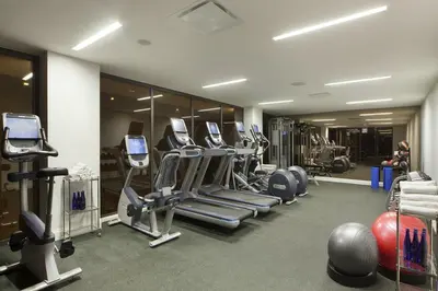 a gym with a bunch of treadms and machines at The Marmara Park Avenue in New York