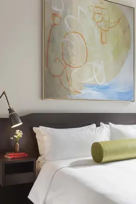 a bedroom with a bed with a painting on the wall at The Marmara Park Avenue in New York