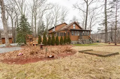 a house with a garden in front of it at The country house in Greenwood Lake