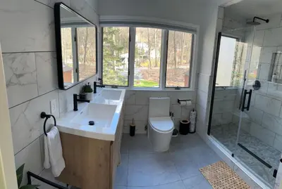 a bathroom with a toilet and a sink and a shower at The country house in Greenwood Lake
