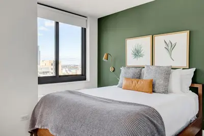 a bedroom with a large bed and a window at Tribeca Studio w Pool Roofdeck Gym View NYC-273 in New York