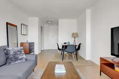 a living room with a couch and a table at Tribeca Studio w Pool Roofdeck Gym View NYC-273 in New York