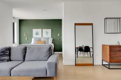a living room with a bed and a couch at Tribeca Studio w Pool Roofdeck Gym View NYC-273 in New York