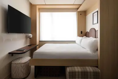 a hotel room with a bed and a window at Motto By Hilton New York City Times Square in New York