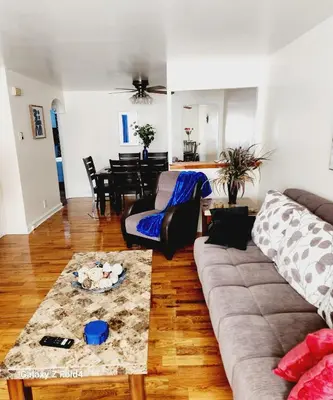 a living room with a couch and a table at Cozy 1 Bedroom Business Suite in Philadelphia