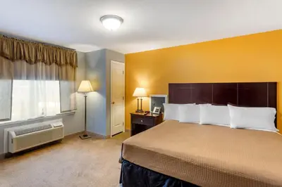 a hotel room with a large bed and a window at The Riverstone Inn in Towanda