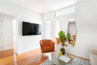 a living room with a chair and a table at 444-3E Contemporary 1BR in Hell's Kitchen in New York