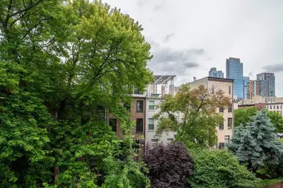 a view of a city with trees and buildings at 444-3E Contemporary 1BR in Hell's Kitchen in New York