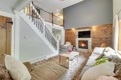 a living room with a couch and a fireplace at Private Hot Tub and Fire Pit Pocono Lake House! in Pocono Lake