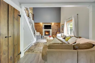 a living room with a couch and a fireplace at Private Hot Tub and Fire Pit Pocono Lake House! in Pocono Lake