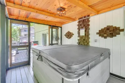 a covered outdoor room with a metal mattress at Private Hot Tub and Fire Pit Pocono Lake House! in Pocono Lake