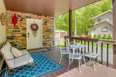 a patio with chairs and a table on a deck at Private Hot Tub and Fire Pit Pocono Lake House! in Pocono Lake