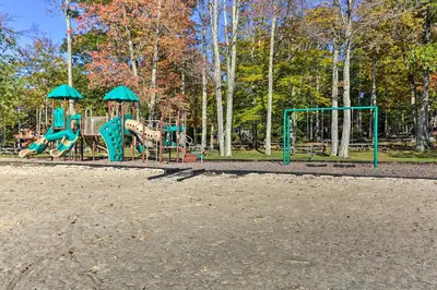 a playground with two play equipment in a park at Private Hot Tub and Fire Pit Pocono Lake House! in Pocono Lake