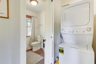 a white refrigerator in a bathroom with a toilet at Private Hot Tub and Fire Pit Pocono Lake House! in Pocono Lake