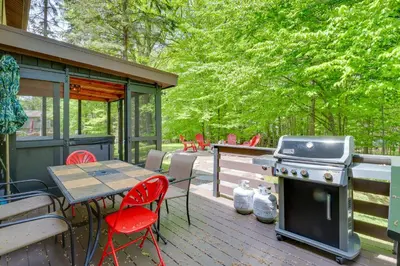 a patio with a table and a grill and chairs at Private Hot Tub and Fire Pit Pocono Lake House! in Pocono Lake
