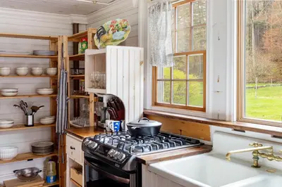 a kitchen with a stove and a sink at The Tannery House in Claryville