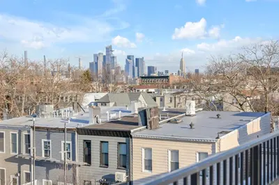 a view of a city skyline from a building at SkyHouse JC - New 3BR Apt with Private Rooftop in Jersey City